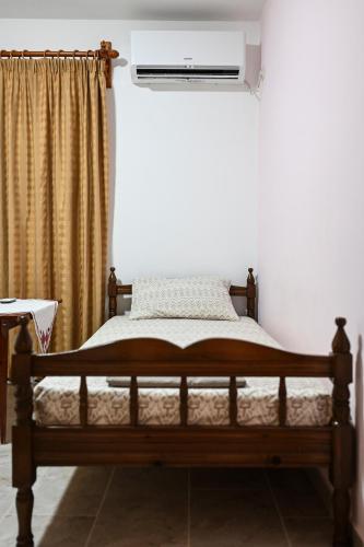 a bedroom with a bed with a air conditioner at morfo's sunset in Sounio
