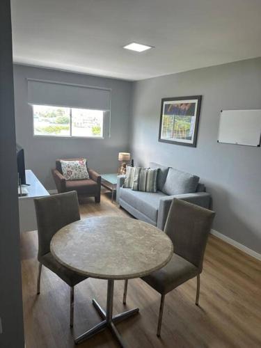 a living room with a couch and a table at Apartamento aconchegante in João Pessoa