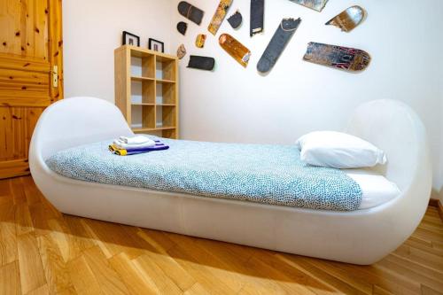 a bed in a room with a white chair at Charme Maison - Ticino - YouStay in Mendrisio