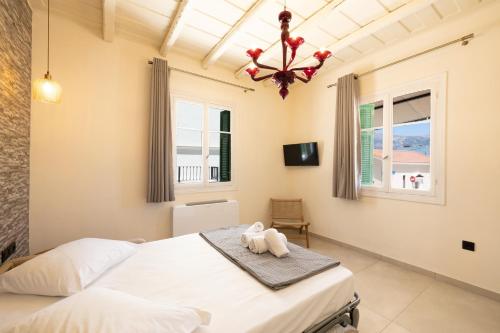 a bedroom with a bed with a stuffed animal on a towel at ARCHONTIKO 1922 in Argostoli