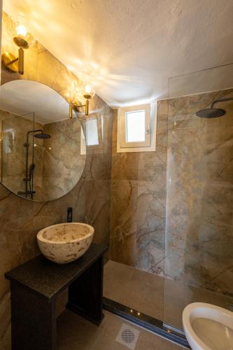 a bathroom with a sink and a shower at ARCHONTIKO 1922 in Argostoli