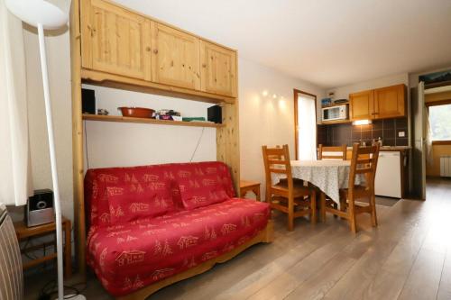 un salon avec un canapé rouge et une table dans l'établissement Résidence Le Prarion 2 C - Prarion 2 Bât A MAE-6413, aux Houches
