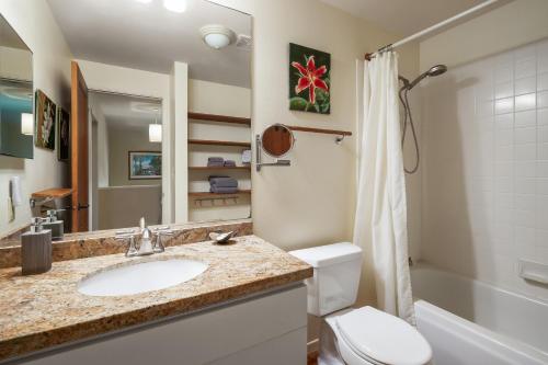 a bathroom with a sink and a toilet and a shower at (HH9B) Classic Hawaiian Hale Honu 2br 2ba in Princeville