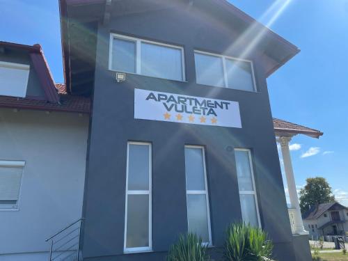 a house with a sign that reads apartment villa at Apartment Vuleta Deluxe Extra groß in Prijedor