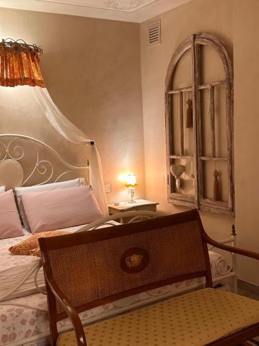 a bedroom with a bed and a table with a lamp at LE LANTERNE in Villa dʼAlmè
