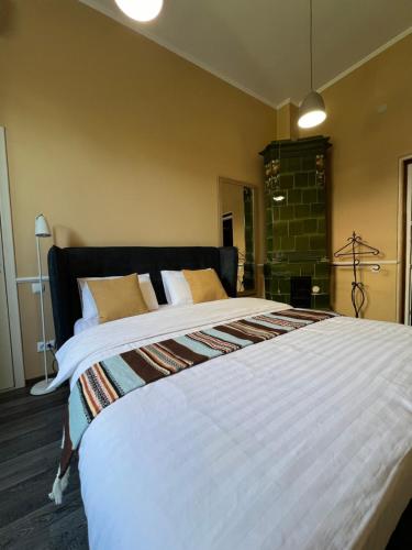 a bedroom with a large white bed with yellow pillows at Kavaler inn hotel in Kuty