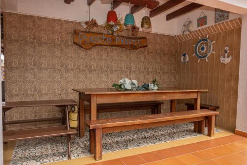 a room with a table and two benches and a sign at Lago Calima - Bella Finca in Madroñal