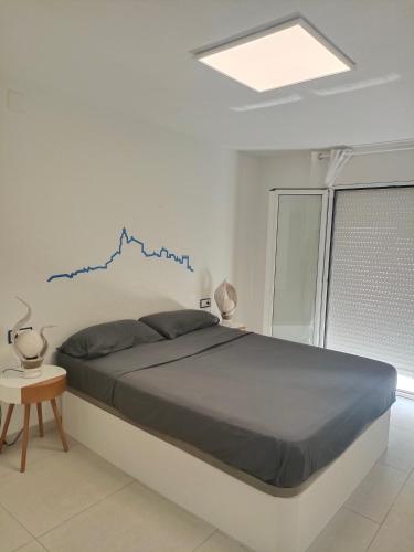 a bedroom with a bed with a blue graph on the wall at Apartamento completo en Cadaqués in Cadaqués