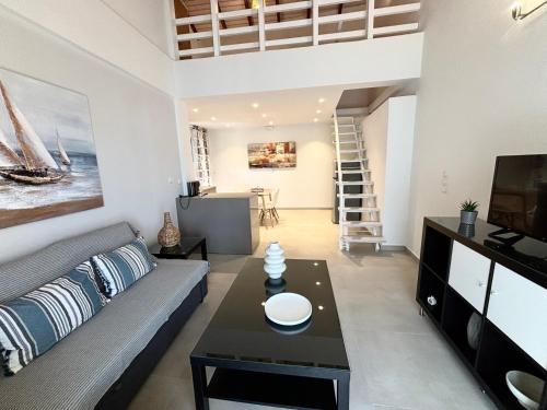 a living room with a couch and a table at Bizaniou Apartment 69 in Preveza