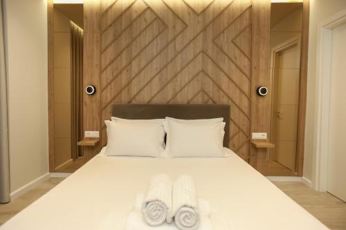 a bedroom with a bed with two towels on it at ReiVal Hotel Marina Vlore in Vlorë