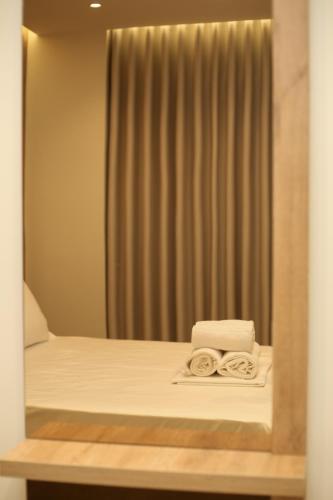 a room with a bed with towels on it at ReiVal Hotel Marina Vlore in Vlorë