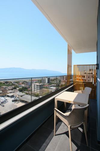a balcony with a table and a view of the ocean at ReiVal Hotel Marina Vlore in Vlorë