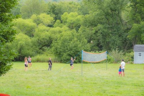 a group of people playing volleyball in a field at Malkita Aria Mountainview Retreat in Woodbury