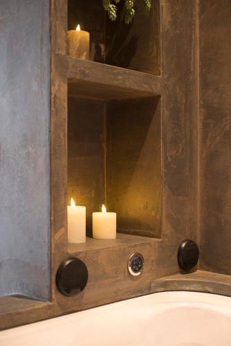 two candles are sitting in front of a mirror at Suite elegance Scheveningen in The Hague