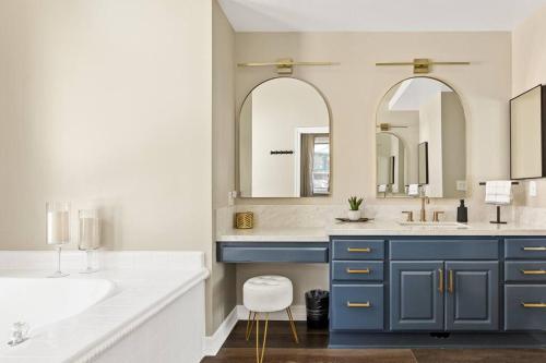 a bathroom with a sink and two mirrors at Oak Mountain Retreat, Hot Tub, & BBQ, Game Room! in Lake Arrowhead