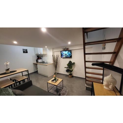 un salon avec un canapé et une télévision dans l'établissement Petite maison, à Nogent-le-Rotrou