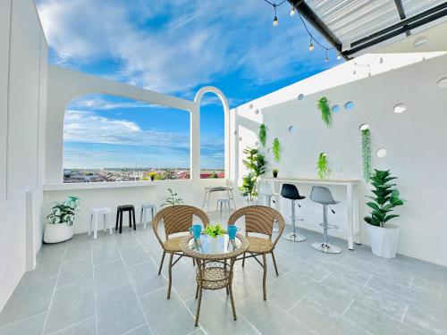 a patio with a table and chairs and a view at White House31 EntireHouse & Rooftop DMK Airport & BTS BKK in Ban Sai Mai