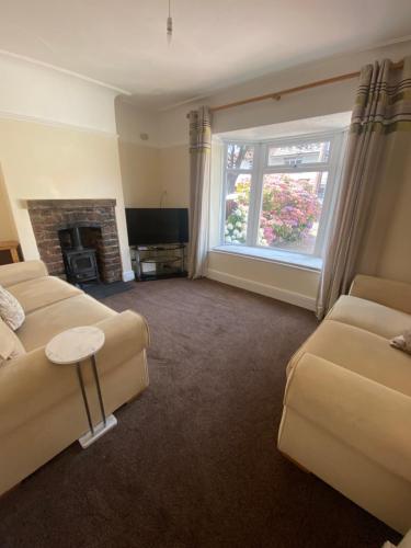 a living room with two couches and a fireplace at Lovely 3 bed house in Crosby in Crosby
