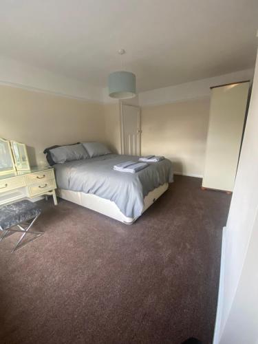 a bedroom with a bed and a dresser in it at Lovely 3 bed house in Crosby in Crosby
