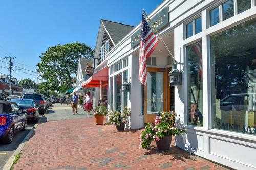 a street with a flag on the side of a building at Game Room Walk to Nantucket Sound in Chatham