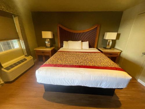 a bedroom with a large bed with two night stands at The INN ON 66 in Flagstaff