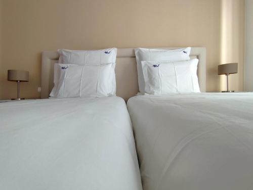 Postel nebo postele na pokoji v ubytování Luso Village Boutique Hotel
