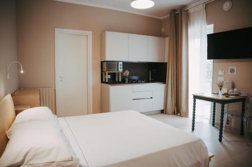 a bedroom with a bed and a table and a microwave at Olivia La Casa sul fiume in Terracina