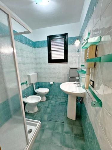 a bathroom with two toilets and a sink and a shower at Marchetti Home in Pantelleria