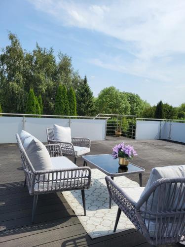 a patio with chairs and a table on a deck at Stilvolle Studiowohnung mit Sonnenterasse in Rheda-Wiedenbrück