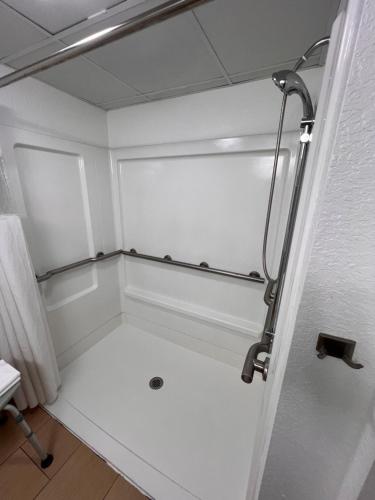 a small bathroom with a shower in a room at Country Inn & Suites by Radisson, Pigeon Forge South, TN in Pigeon Forge