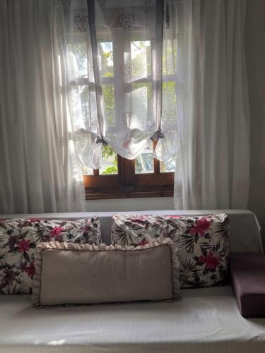 a couch sitting in front of a window at Margianou Seaview Apartments 3 & 4 in Kálamos