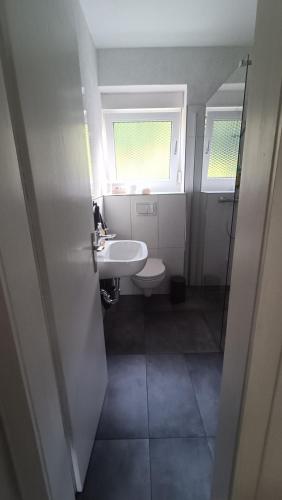 a small bathroom with a sink and a toilet at FeWo Deisterferien, Terrasse, Netflix, Wlan, A2, B65, Steinhude, bis 8 Personen in Beckedorf