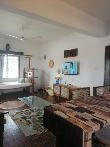 a living room with a table and a couch at Mavericks Convenient Cozy Loft in Diani's CBD in Ukunda