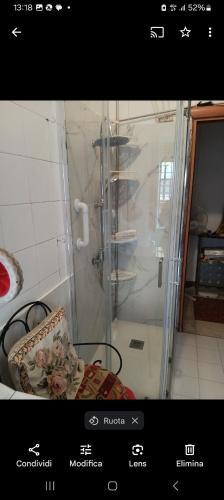 a shower with a glass door in a bathroom at Casa Revello in Milan