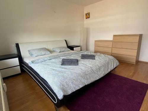 a bedroom with a bed with two pillows on it at Sunset view, near the airport & private parking in Dvorník