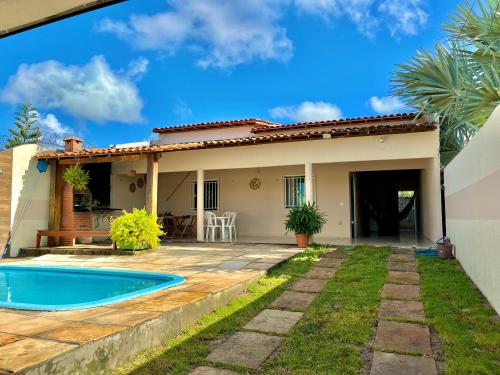 a house with a swimming pool in front of it at Casa por temporada Bhs in Barreirinhas