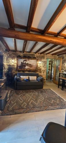 a living room with a couch on a rug at Rustic Retreat-Country House in Tondela