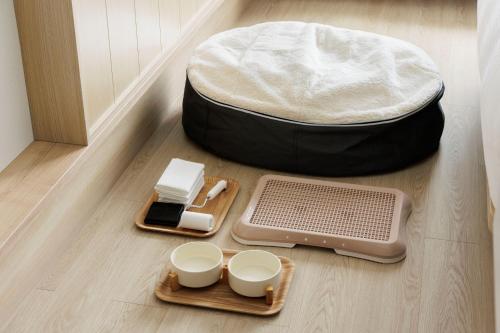 a ottoman sitting on the floor with bowls and plates at Fairfield by Marriott Kyoto Kyotamba in Nantan city