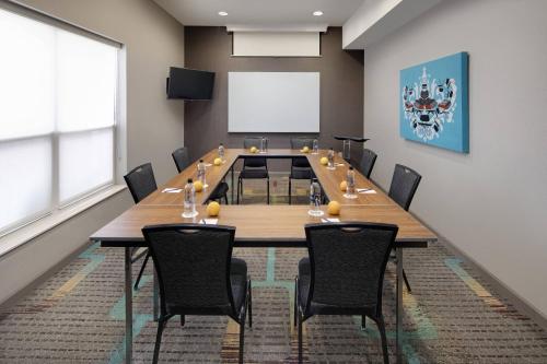 a conference room with a long table and chairs at Residence Inn Indianapolis Airport in Indianapolis