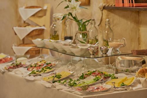 a table with plates of food and wine glasses at Baron Boutique Hotel in Jelenia Góra