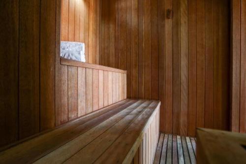a wooden sauna with a bench in a room at Hotel Av Rouxinol 57 Moema São Paulo 09 in Sao Paulo