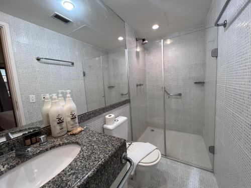 a bathroom with a shower and a sink and a toilet at Hotel Av Rouxinol 57 Moema São Paulo 09 in Sao Paulo