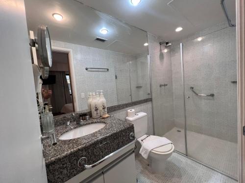 a bathroom with a toilet and a sink and a shower at Hotel Av Rouxinol 57 Moema São Paulo 09 in Sao Paulo