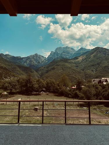 a view of a mountain range from a fence at Vila Shkalla in Theth