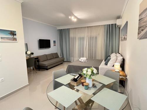 a living room with a couch and a table at Irene Beach Front Luxury Suite in Perea