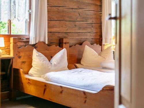 a bedroom with two beds with white sheets and pillows at Alpin Hideaway XL in Bruggberg