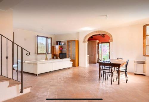 a living room with a table and a couch at Villa Caini in Perugia