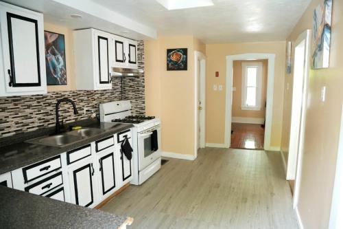 a kitchen with a sink and a stove at The Freedom HOME from HOME in New Bedford