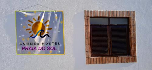a sign on the side of a building next to a window at Hostel Summer Praia do Sol in João Pessoa