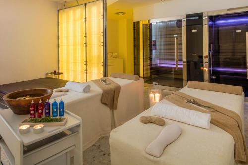 a spa room with two beds and a mirror at Hotel Bellevue in Mali Lošinj